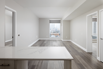 an empty living room with a table and a window
